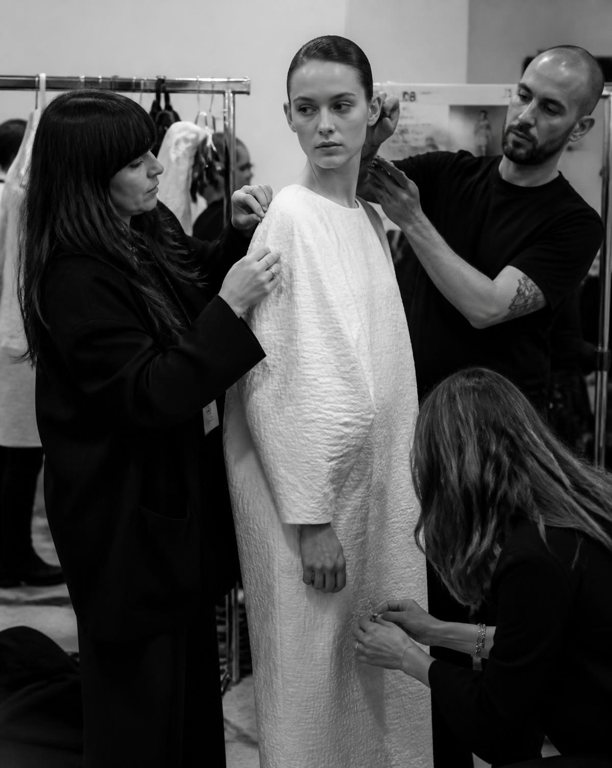 Creative team preparing a model backstage