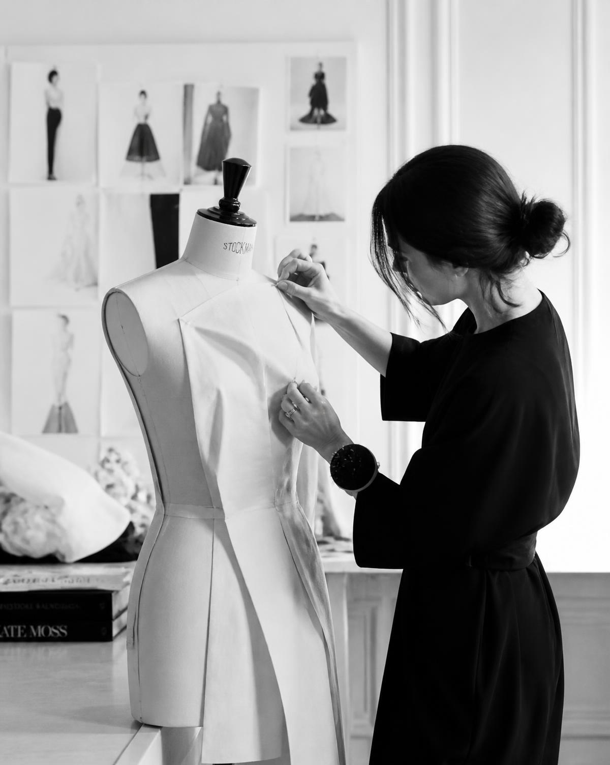 Designer draping a garment in an atelier