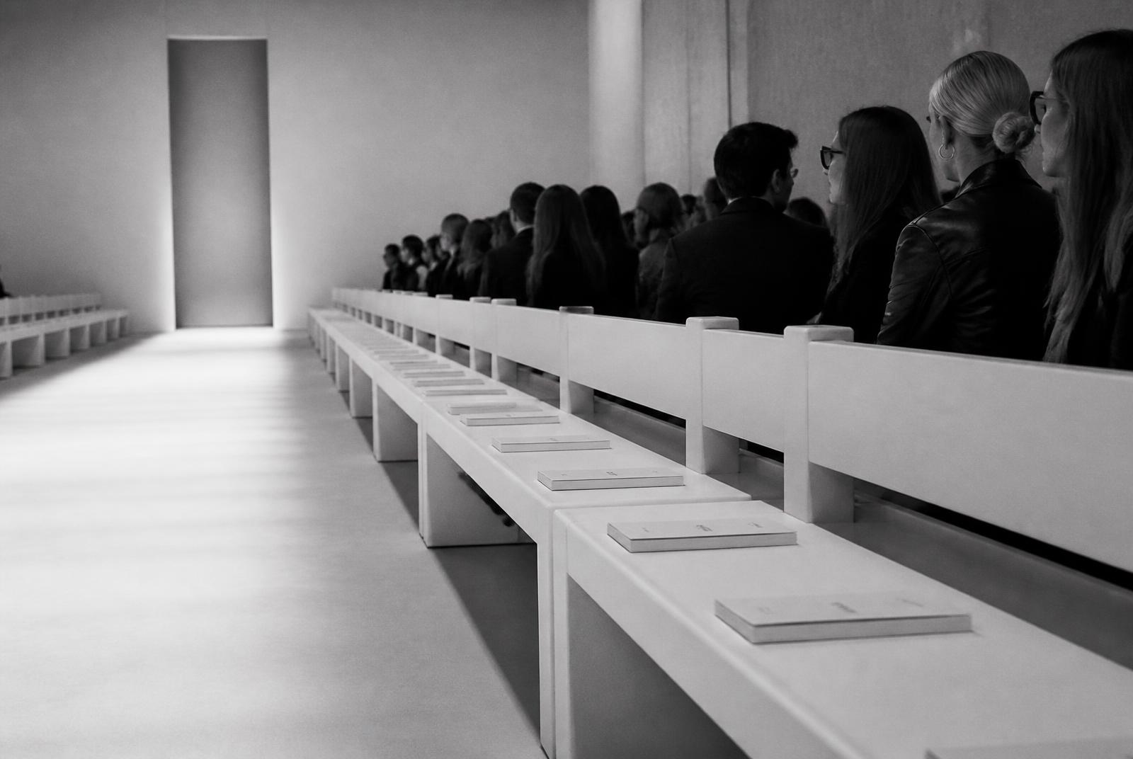 Front row seating and show notes before a produced runway presentation